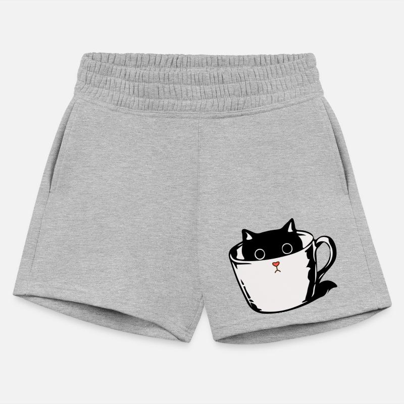 Black kitten with red nose hiding in a cup