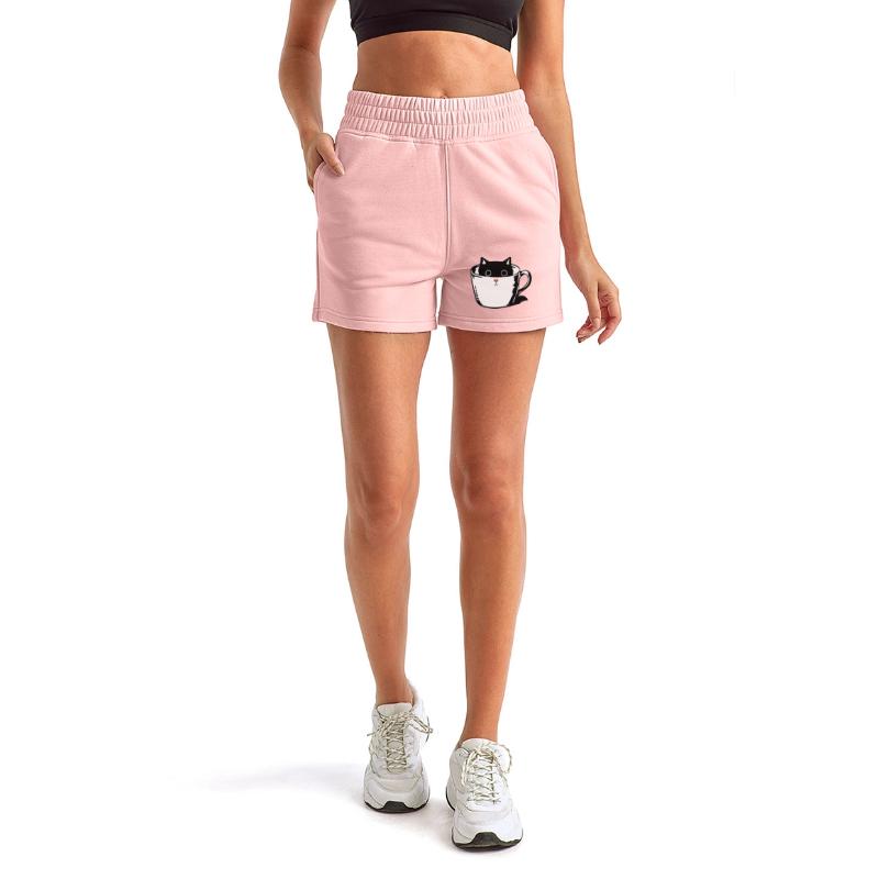 Black kitten with red nose hiding in a cup